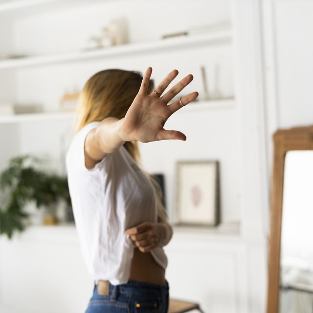 abuse and violence against women, woman raising hand at home