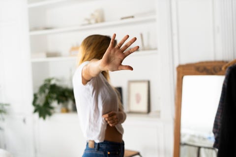 abuse and violence against women, woman raising hand at home