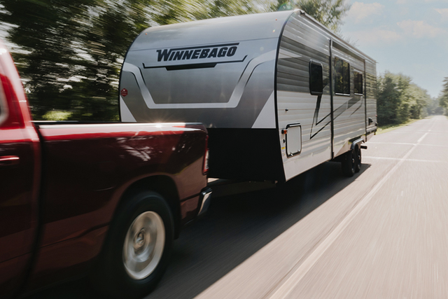 winnebago access trailer being towed by a truck