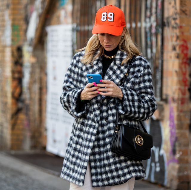 berlin, germany   october 28 sonia lyson is seen wearing jogger pants edited, checkered black white coat and orange cap dorothee schumacher, black louis vuitton pont 9 bag on october 28, 2020 in berlin, germany photo by christian vieriggetty images
