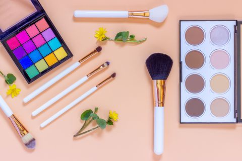 Accessories for professional decorative cosmetics.  Makeup brushes eye shadow contouring palette contour on color background.Flat lay top view. Make-up and beauty concept.