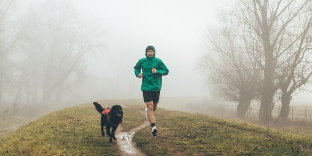 active young man jogging with his dog