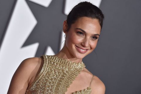 gal gadot in a gold one shoulder dress at the premiere of warner bros pictures' "justice league"
