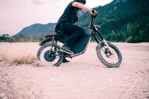 blacktea moped electric motorcycle driving in dirt
