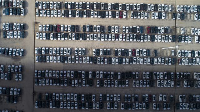 aerial view of general motors storage parking with new cars at shanghai pudong district,shanghaihalf under bright,half in shadow