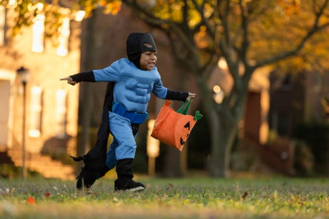 african american boy trick or treating on halloween