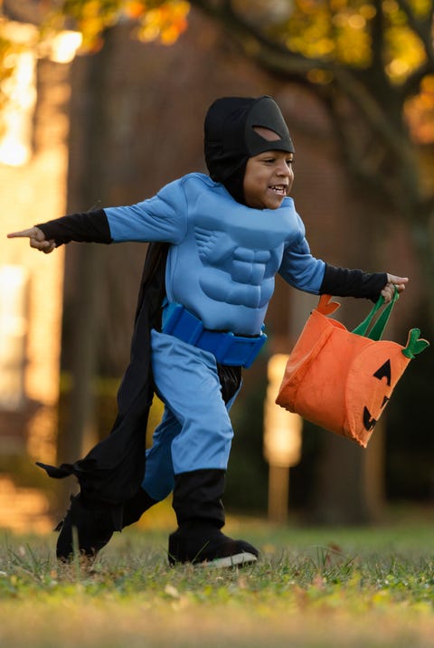 African American boy trick-or-treating on Halloween african american boy trick or treating on halloween