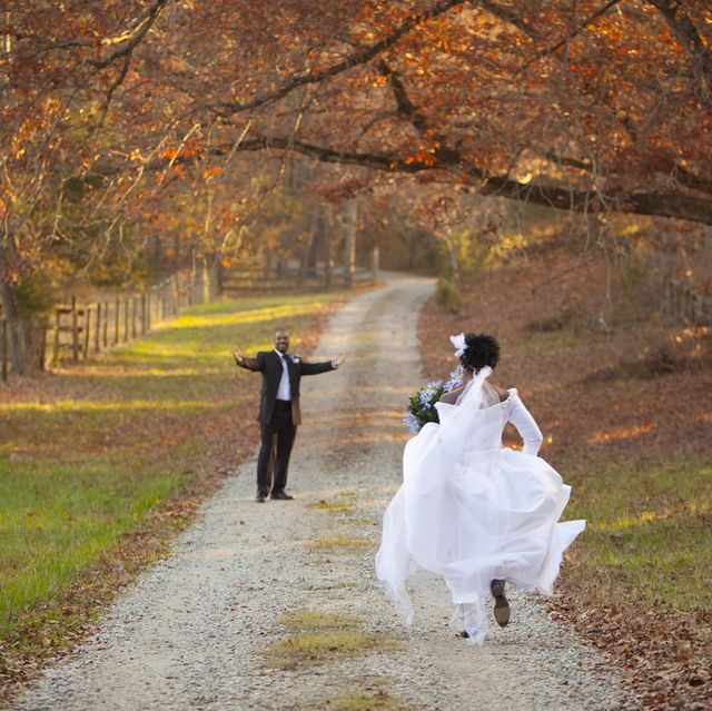 african american bride and groom running to each other on path