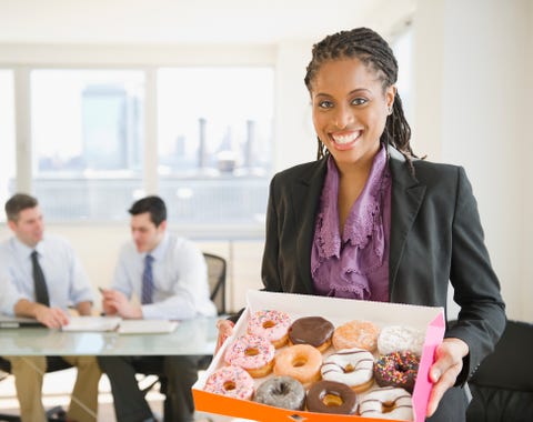 african american businesswoman carrying box of donuts, follow News Without Politics for updates, unbiased