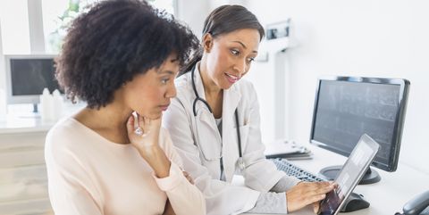 african american doctor and patient talking in office