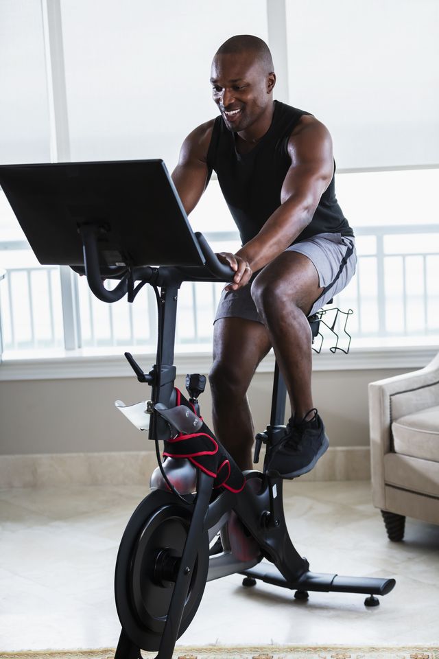 african american man on exercise bike at home