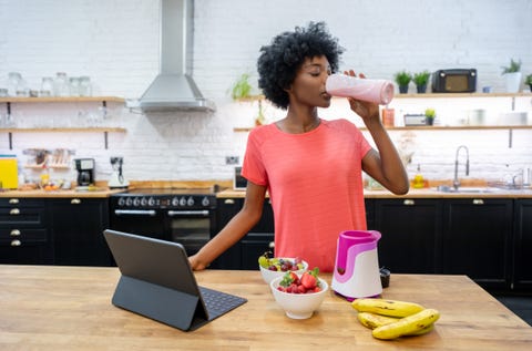 African American woman at home drinking a smoothie african american woman at home drinking a smoothie