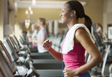 african american woman exercising on treadmill in gym