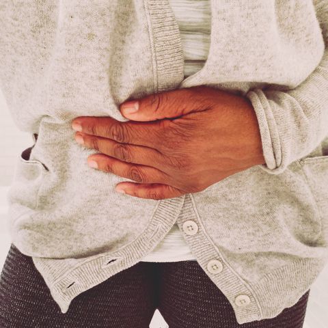 african american woman experiences stomach pain