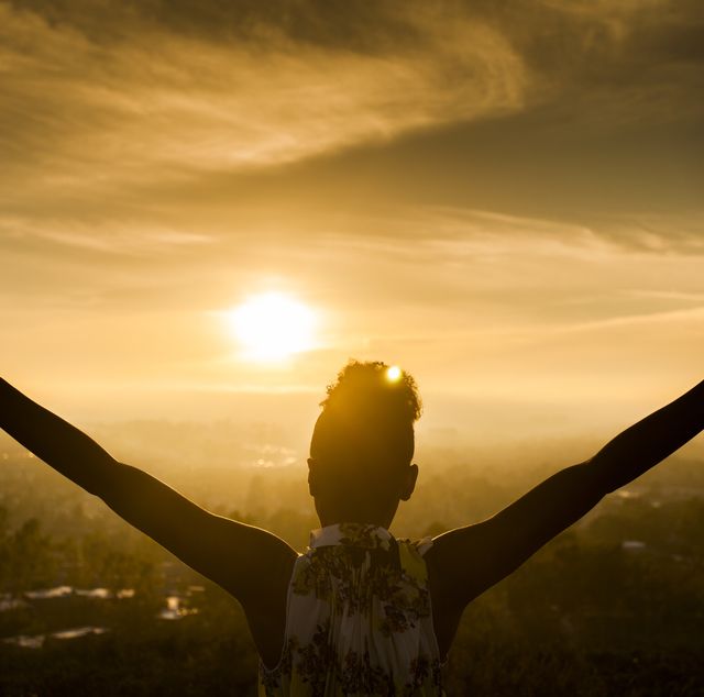 bible verses about life  woman holding her arms out wide facing the sun