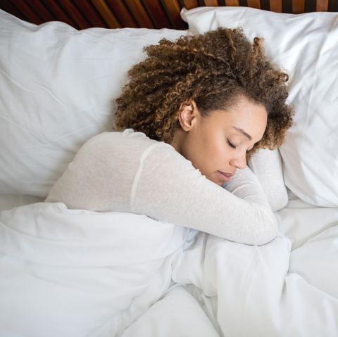 African American woman sleeping in bed