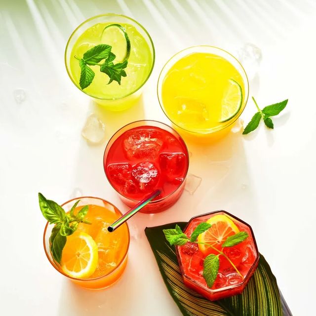 multiple glasses of red, yellow and orange agua fresca