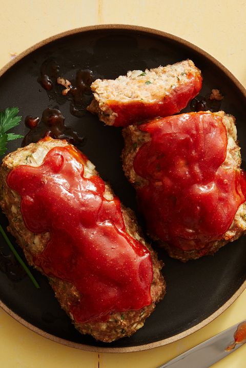 air fryer turkey meatloaf topped with ketchup on a black plate