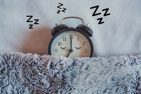 Alarm clock sleeping in bed