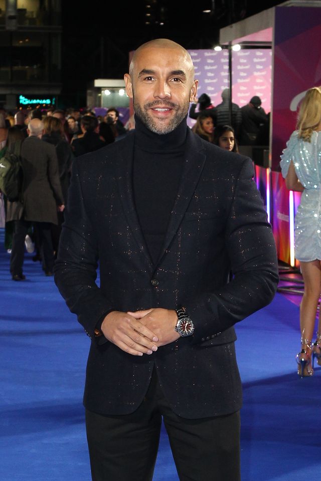 alex beresford smiles for photographers as he attends a red carpet event