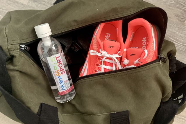 alkaline88 sport water on a gym bag with running shoes