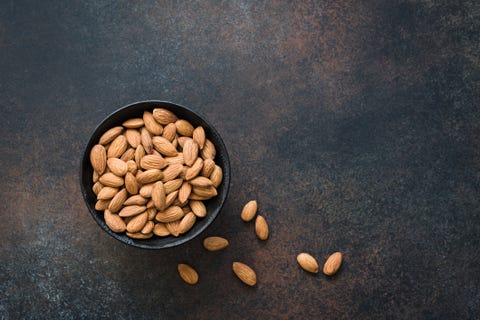 almonds in bowl on background
