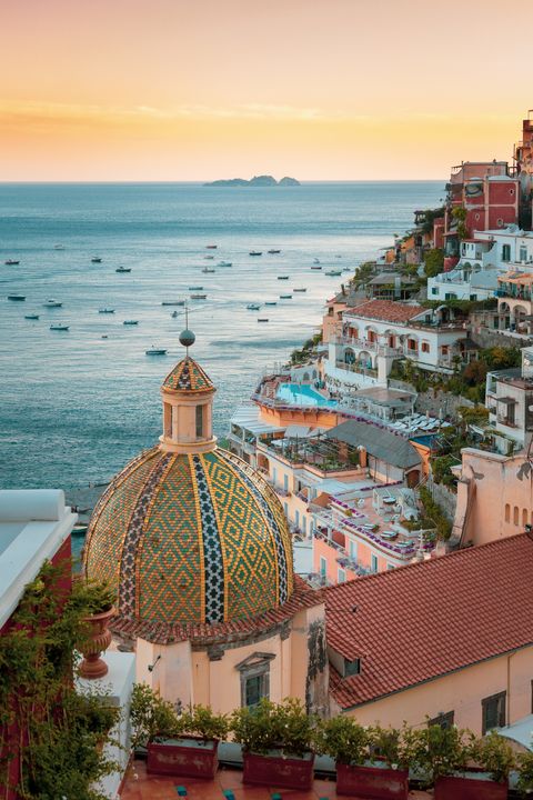 positano, amalfi coast, campania, sorrento, italy view of the town and the seaside in a summer sunset