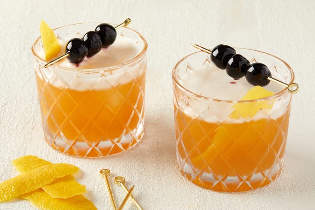 Amaretto Sours two amaretto sours garnished with cherries