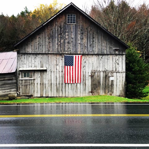 american-flag-on-wooden-house-by-wet-road-royalty-free-image-1589224538.jpg?crop=0.862xw:0.862xh0.0476xw,0.00340xh&resize=480:*