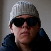 a man wearing sunglasses and a beanie