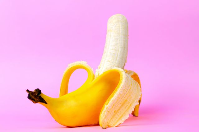 an open banana symbolizing the male sexual organ in an erect state pink background concept of potency and men's health and strength