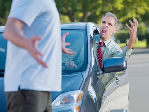 Angry driver shouting at pedestrian blocking road