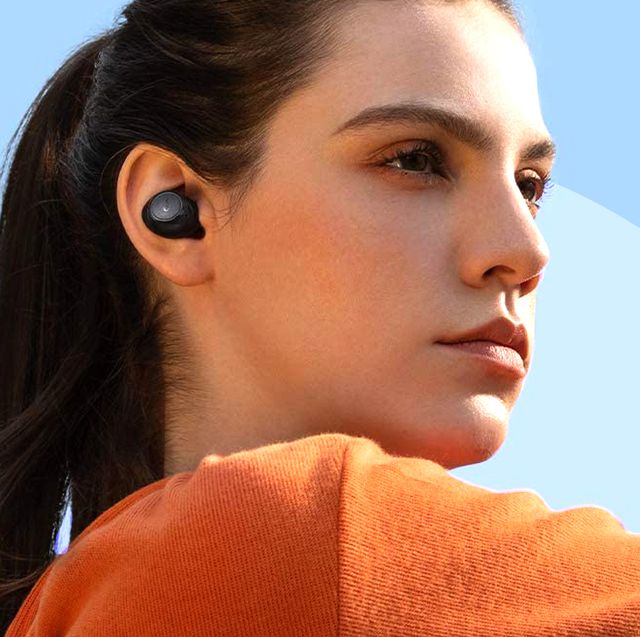 woman stretching with soundcore by anker wireless earbuds