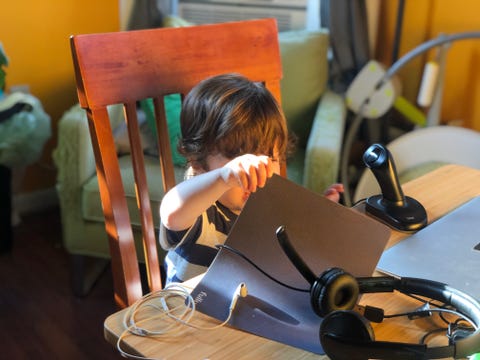 my son playing in my bedroom workspace