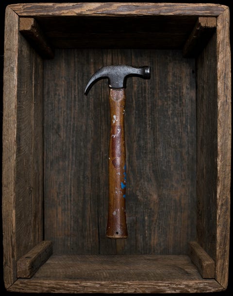 Antique hammer floating in old box