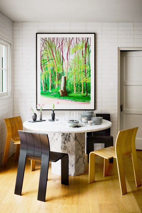 eclectic dining nook with marble table and green wall art