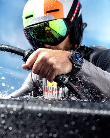 a man in a helmet and goggles in the water wearing panerai luminor marina carbotech luna rossa