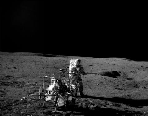 Apollo 14 mission. Astronaut Alan Shepard near Modular Equipment Transporter (MET) on lunar surface.