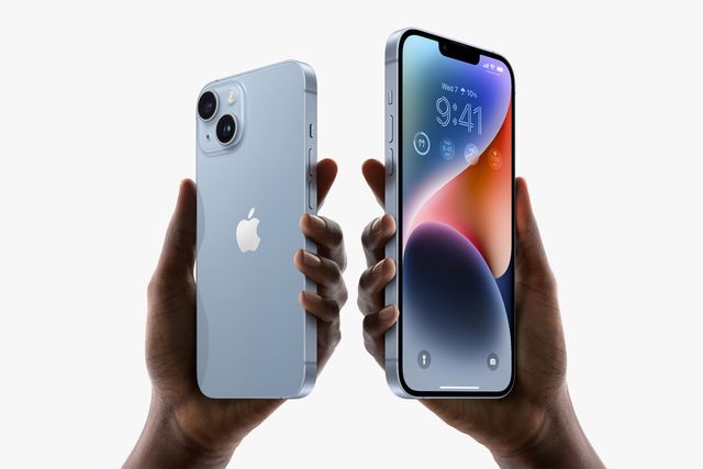 two hands holding iphones