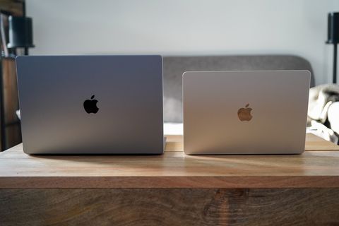 two macbooks open on a table