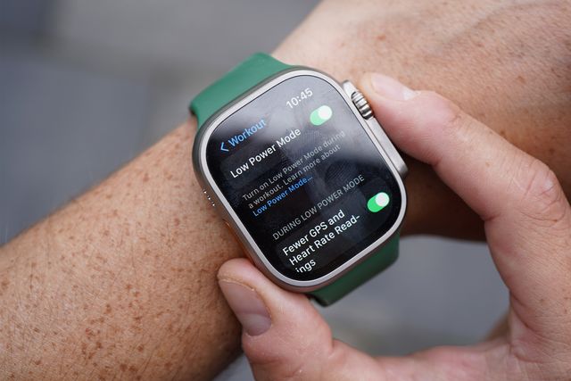 an apple watch ultra watch on a wrist with the low power mode being set on the screen
