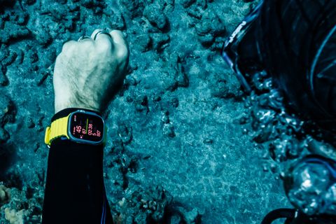 a person scuba diving wearing an apple watch ultra