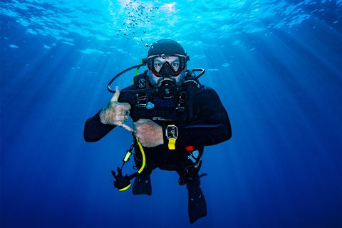 a person scuba diving wearing an apple watch ultra