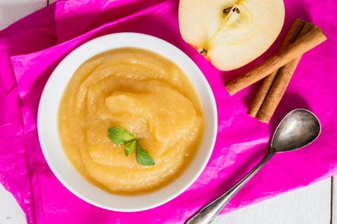 Applesauce on pink paper and spoon