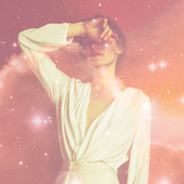 a white woman in a white dress raises her hand up against her face, and a pink starry sky filter is laid over her