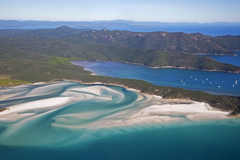 Areal view of white sandy beaches and turquoise blue water of Whitehaven Beach on Whitsunday Island in the Coral Sea