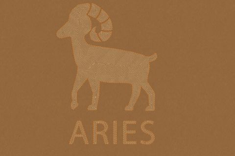 aries horoscope sign in paper craft brown background