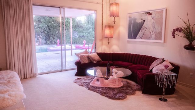los angeles, california, united states   november 14, 2019   pink retro living room in jamie nelson's house a fashion photographer has transformed her la home into a 1970's version of barbie's dreamhouse hidden away in the san fernando valley lies a pink pillared mansion with a matching convertible parked outside jamie nelson, 36, has made a name for herself in the fashion industry, photographing the likes of drew barrymore and gwen stefani as stylish as her subjects, you could easily assume the pink spinning bed or the fur walled bathroom that features on jamie's instagram is just a part of her job however, this is jamie's not so humble abode   boasting fabulous retro interior with a burst of colour inside jamie told barcroft tv "i moved to la from new york city two years ago and i've been creating my dream house ever since i came to la with a pink house in mind" she has spent the last two years transforming the home from a blank canvas into a creation of colour with 70's vibes rather than make the entire house pink, jamie decided each room would take on a different colour and theme "i don't ever get tired of the colours of the rooms because there's a blue room, a yellow room, a red room, a pink room, a gold room" growing up in colorado springs, jamie was always infatuated by visuals of decades gone by and dreamt of becoming an artist from the age of 17, she formulated a plan to live in a pink house, surrounded by pool boys serving her drinks whilst she floated on a pink flamingo jamie has had numerous requests for music videos, fashion campaigns and commercials to be filmed at the house photograph by jacki huntingdon  future publishing     note this photo can only be used within context with the information provided in the metadata photo credit should read jacki huntingdonfuture publishing via getty images
