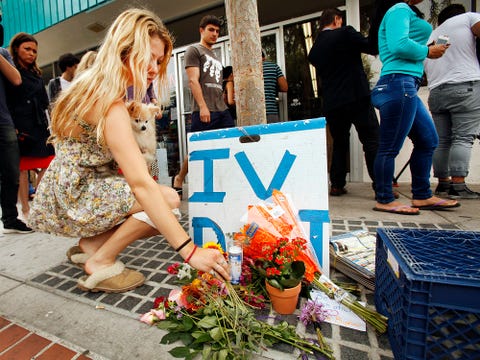 ISLA VISTA, CA MAY 24, 2014 - Arrow Denoyer, a 18 years old freshman places flowers at a growing me isla vista shooting elliot rodger