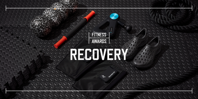 multiple pieces of recovery gear laid out over top black rubber gym flooring with text say fitness awards recovery laid overtop the photo